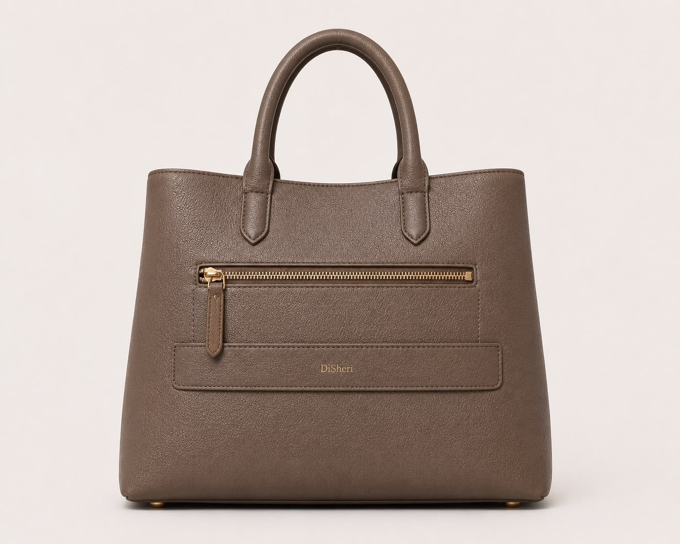 DiSheri taupe leather tote, back view with embossed DiSheri wordmark and zip pocket